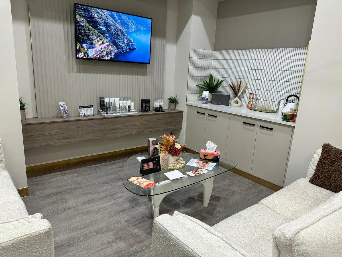 Elegant plum and gold clinic lounge at Estetica Skin and Laser